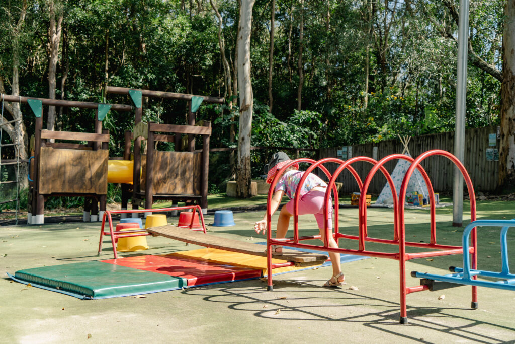 A kindergarten child is exploring the obstacle course at Fireflies Early Learning