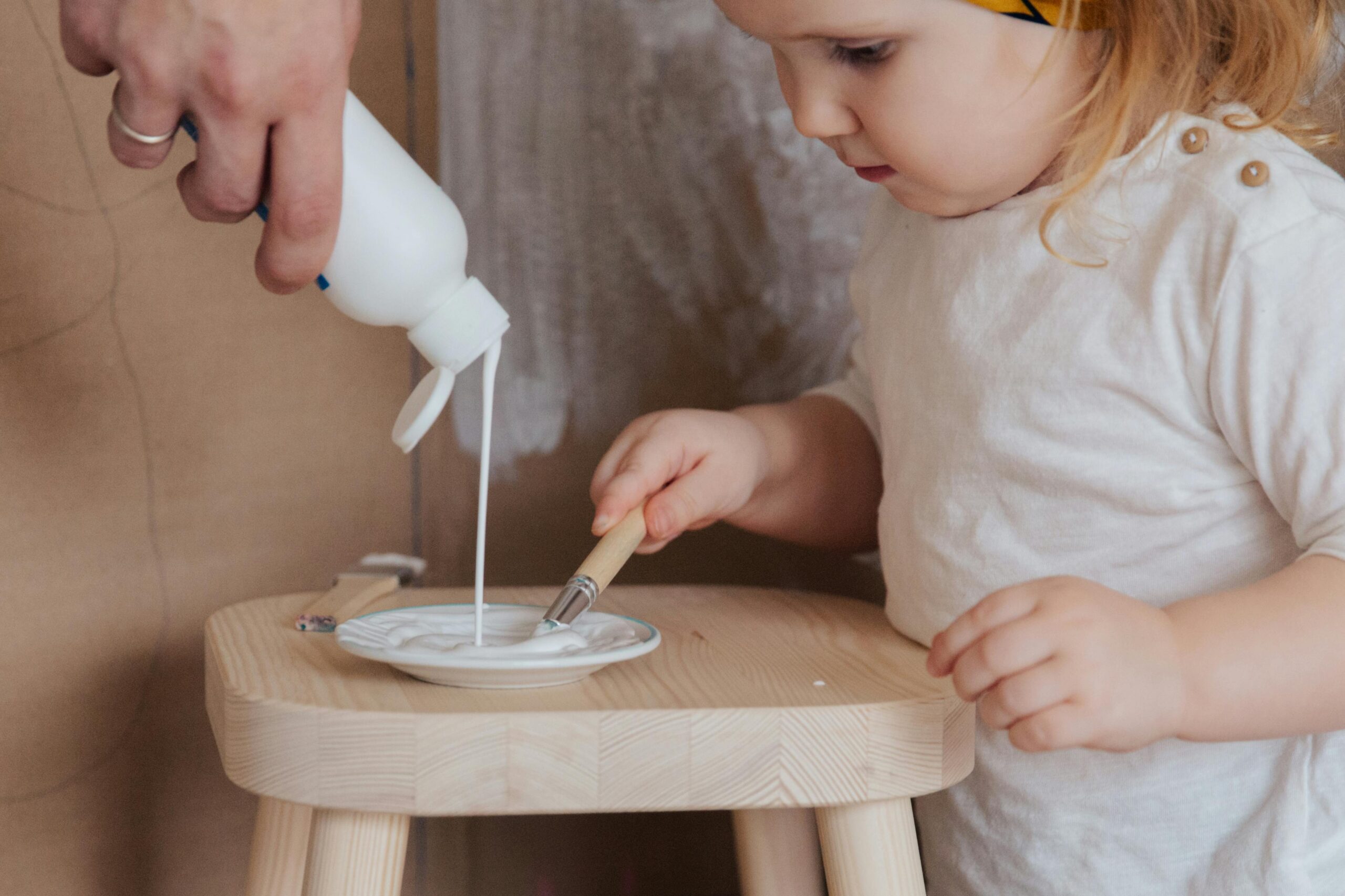 A toddler from Fireflies Early Learning is about to experience painting the first time in her life.