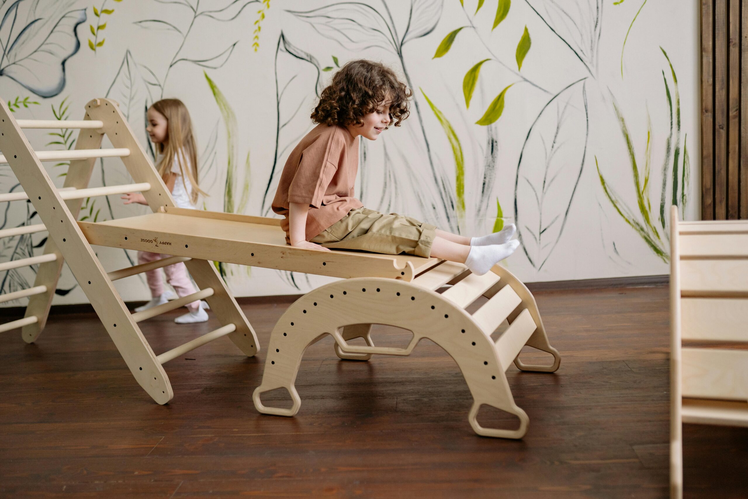 A child sitting on a slide at Fireflies Early Learning