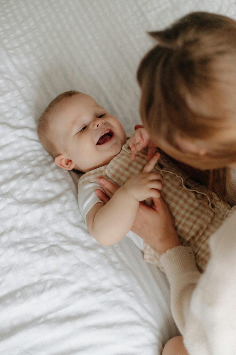 Baby smiling happily at Fireflies Early Learning